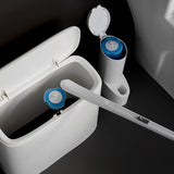 White cleaning brush with blue bristle heads inside a white container on a dark background