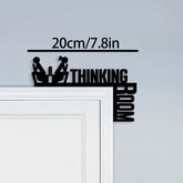 Wall decal with silhouette of two people and text 'THINKING ROOM' on a light gray wall.