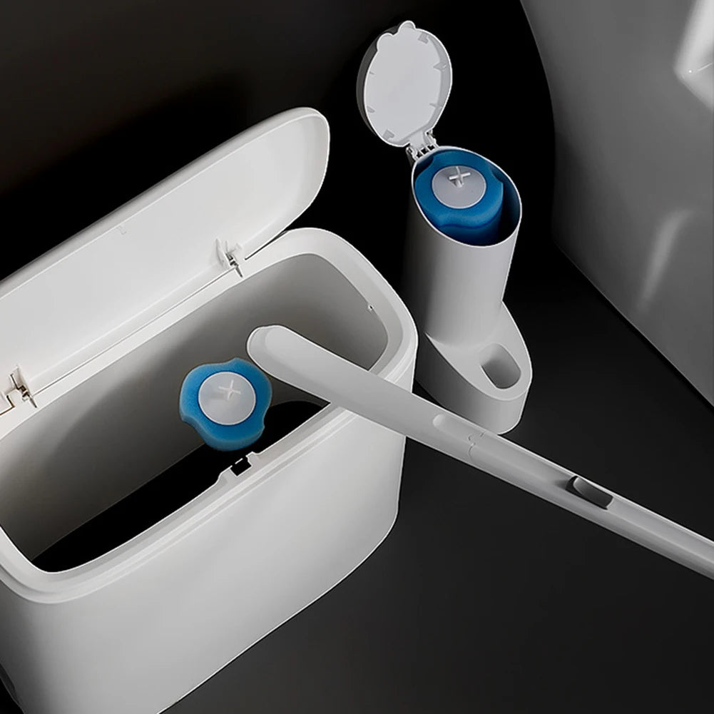 White cleaning brush with blue bristle heads inside a white container on a dark background