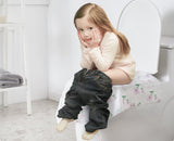 Child sitting on a toilet with text 'Ideal Size for Adults and Children' and icons below.